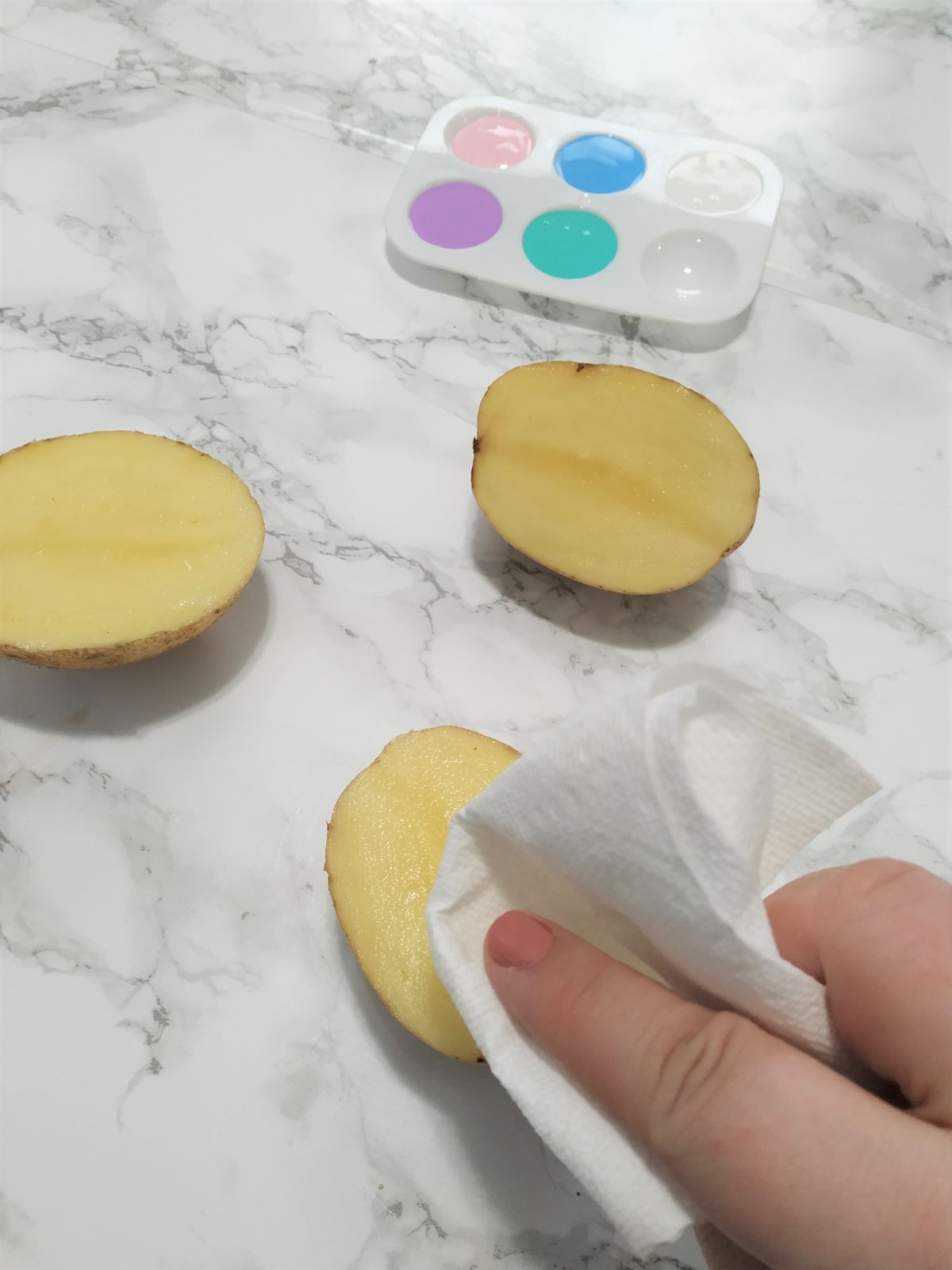 Blotting the inside of the potato with paper towel.