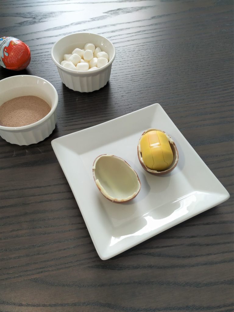 Spliting the kinder egg shells in half.