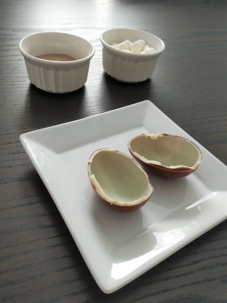 Two pieces of a kinder surprise egg.