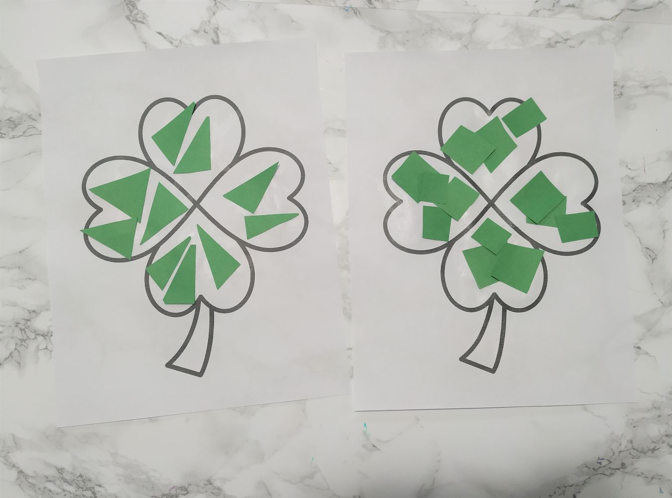 Shamrock coloring pages decorated with green paper shapes.