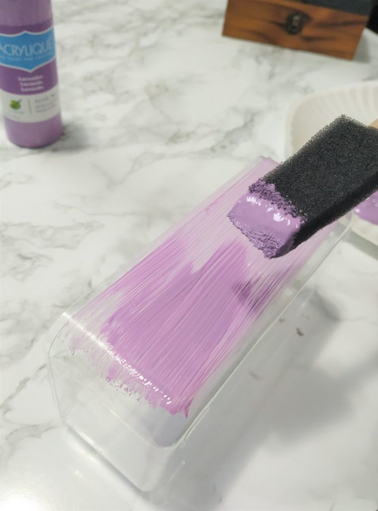 Painting the bottom plastic box purple.