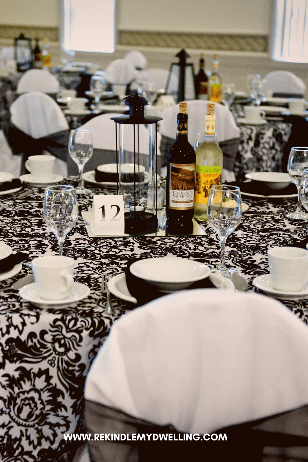 Lamp and wine bottles used as a wedding centerpiece.