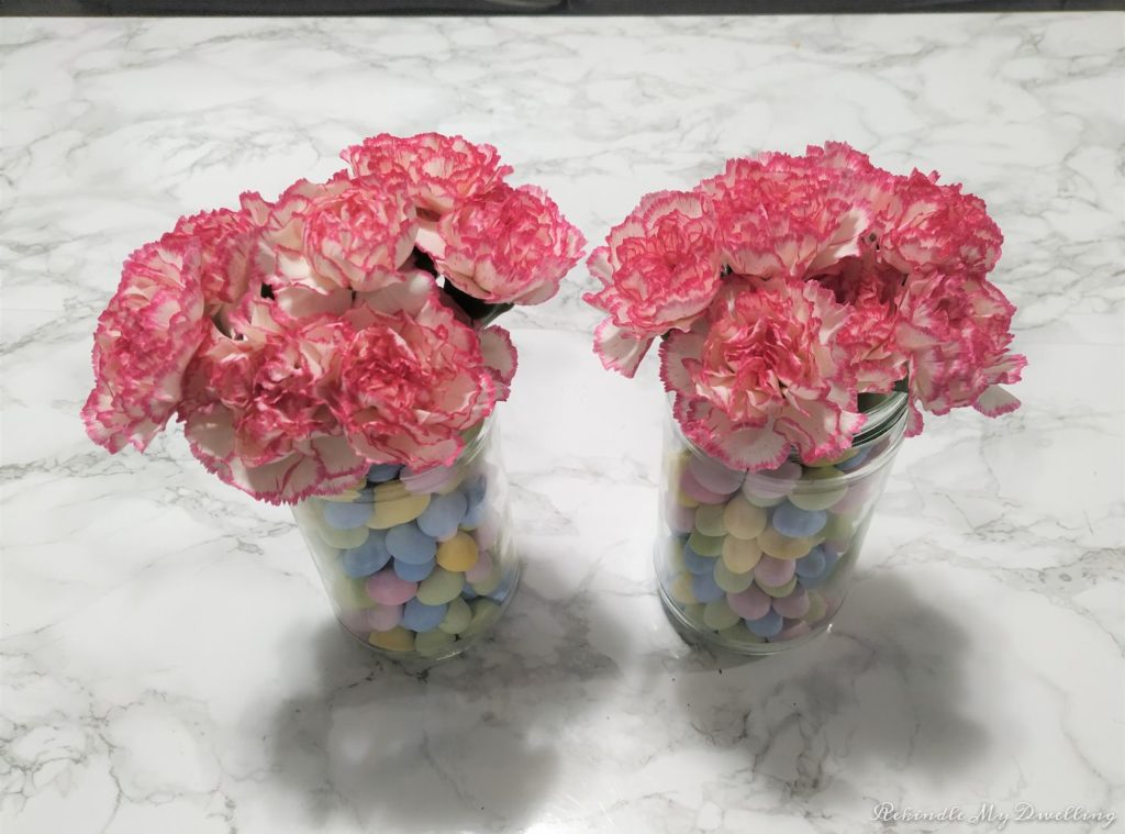 Easter candy jar vases with flowers.