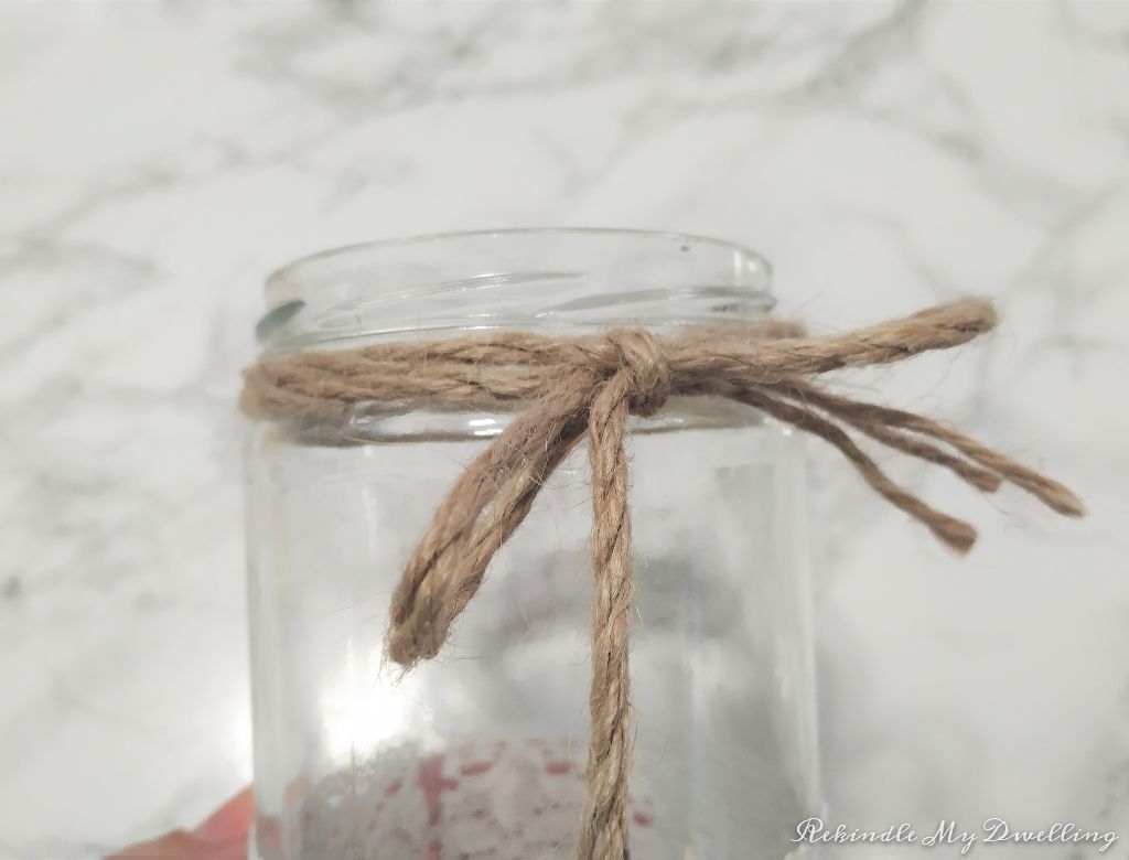 Twine wrapped around the neck of a mason jar.