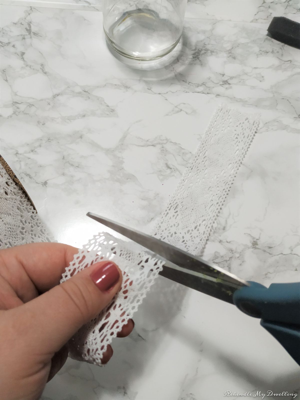 Cutting a piece of lace fabric.