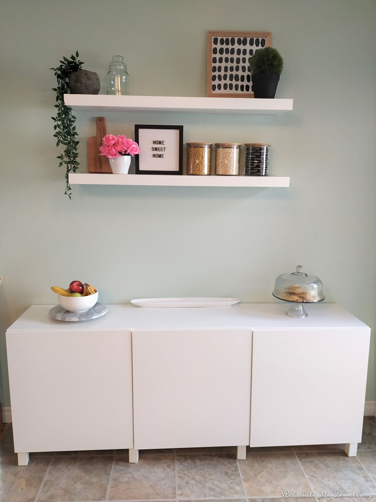 Finished storage makeover with sideboard, floating shelves and decor.