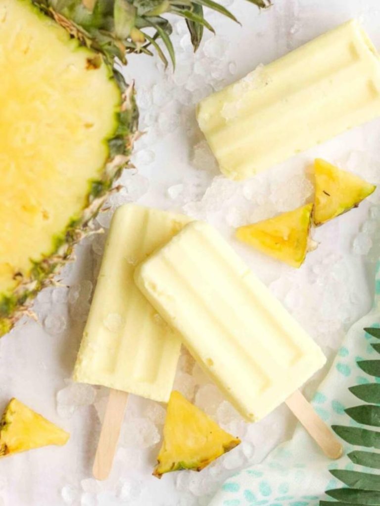 Summer popsicle recipes next to pineapple.