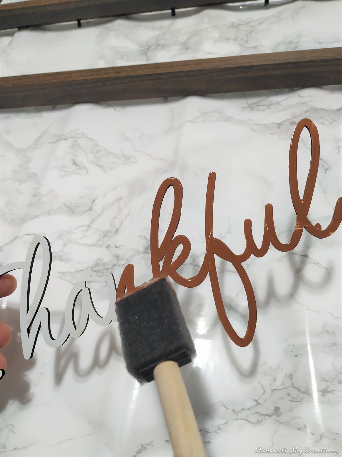 Painting the thankful lettering brown.