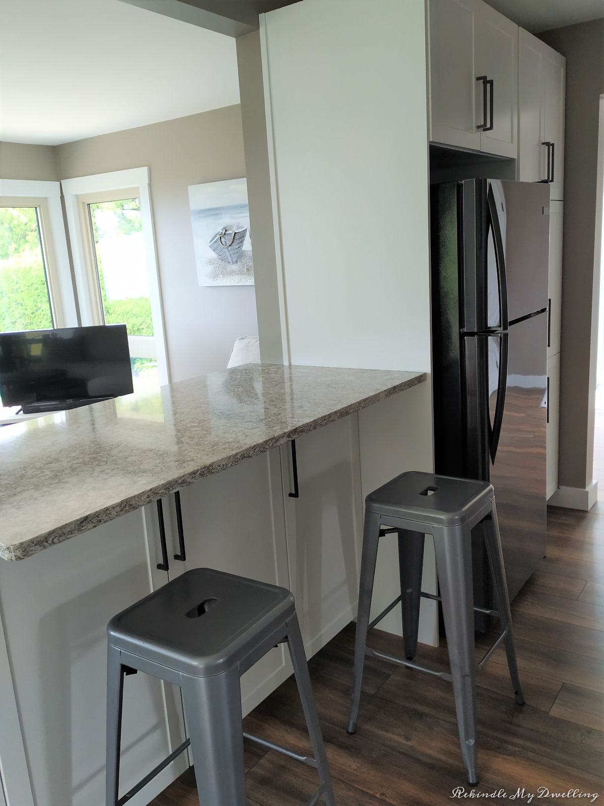 Kitchen stools and fridge.