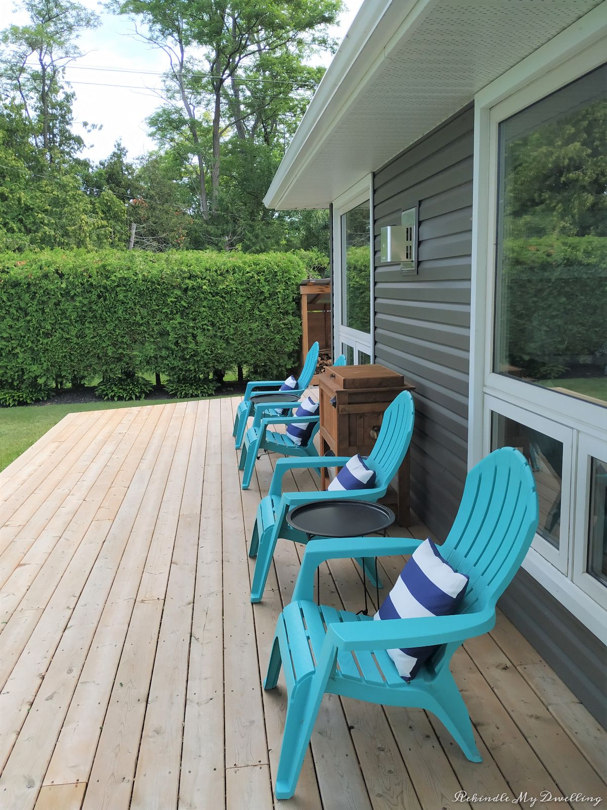 Outdoor deck with blue chairs.
