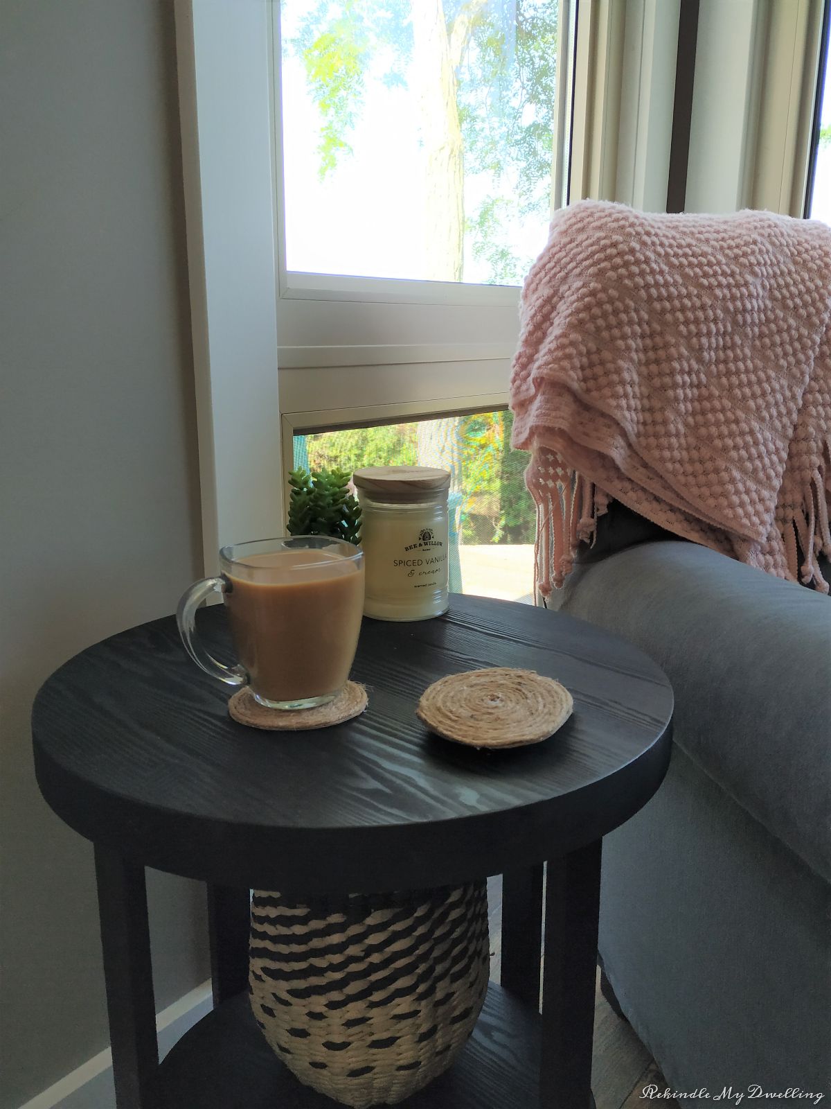 Rope coasters, coffee and decor next to a chair.