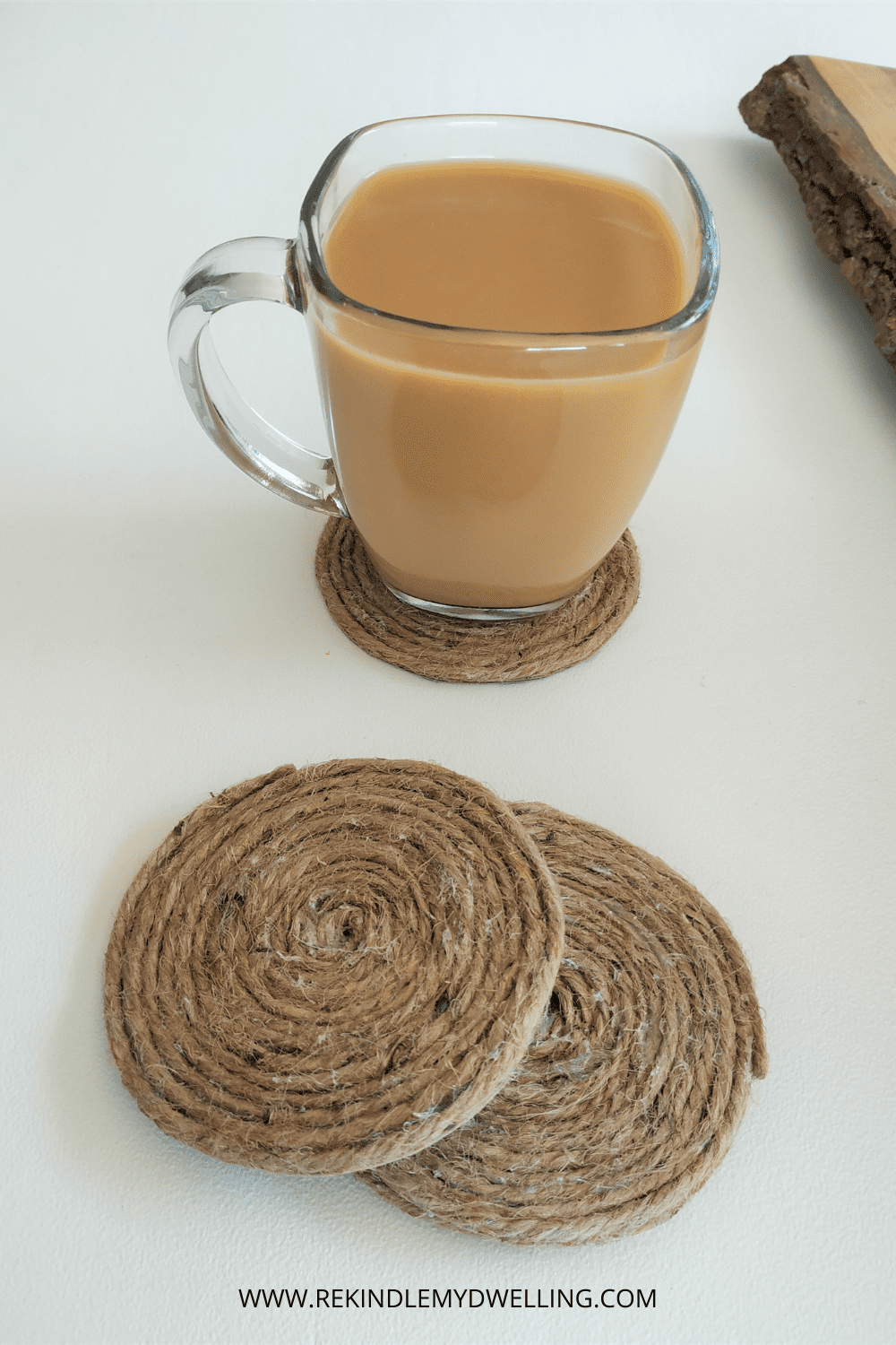 DIY rope coasters stacked with a cup of coffee.