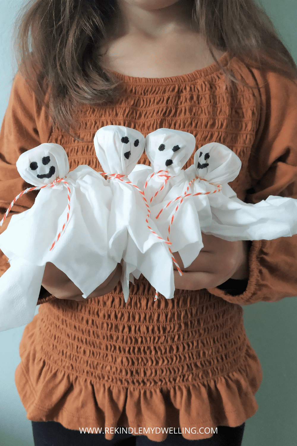 Holding a bunch of diy lollipop ghosts.