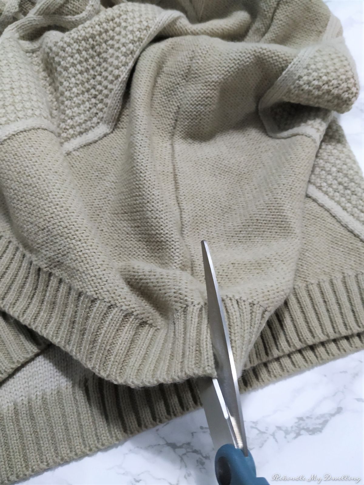 Cutting a sweater at the seams.
