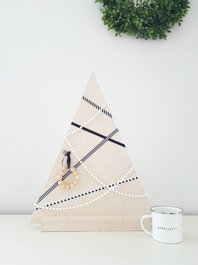 Wooden Christmas tree with ribbon.
