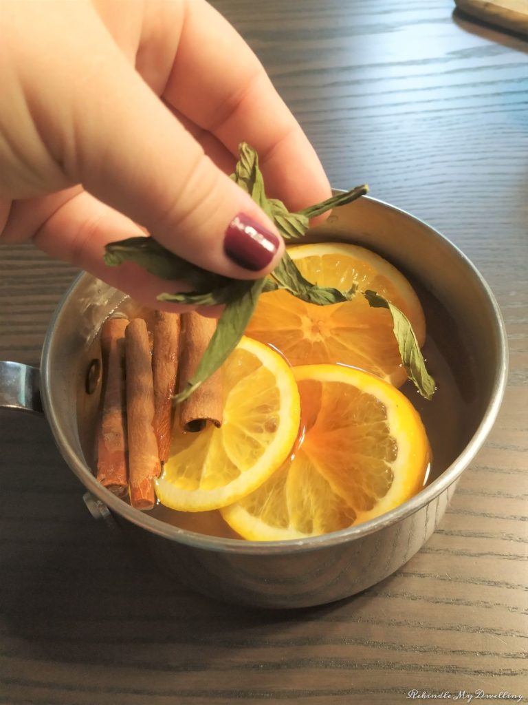 Adding fresh mint into the pot of water.