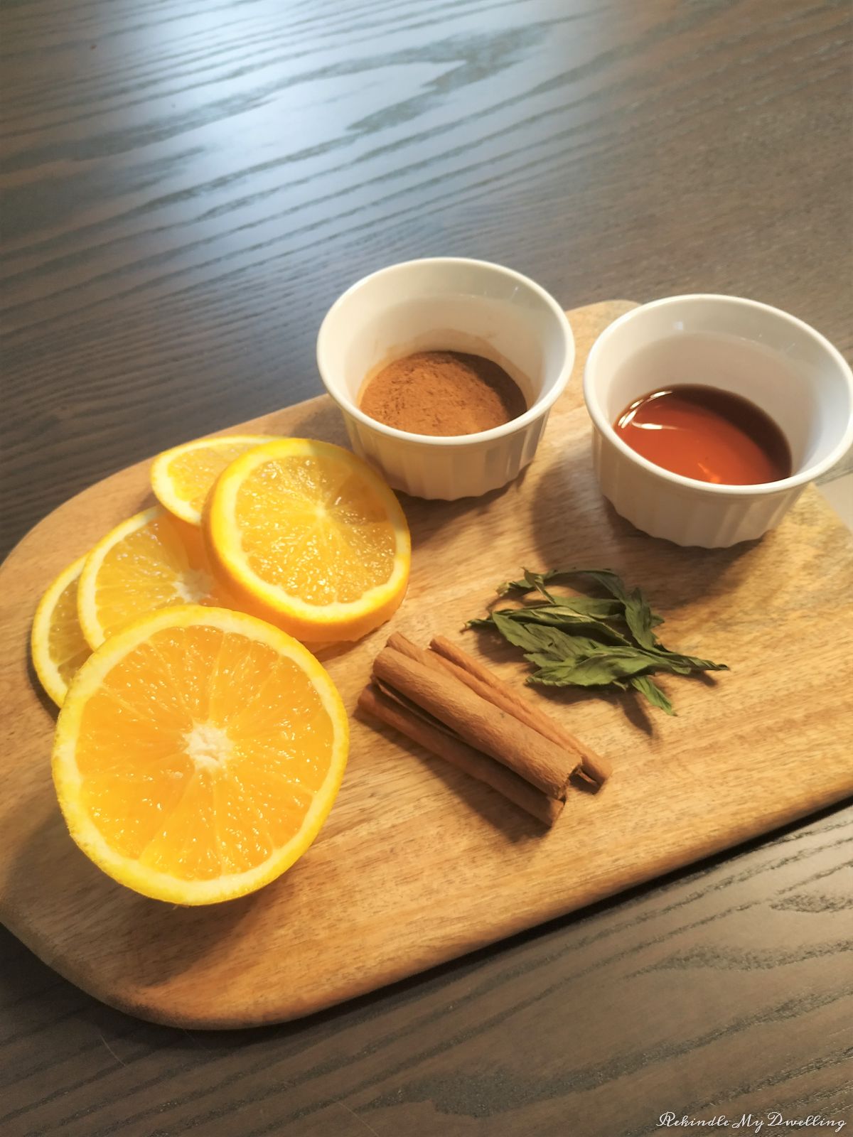 Ingredients needed to make a fall simmering pot placed on a cutting board.