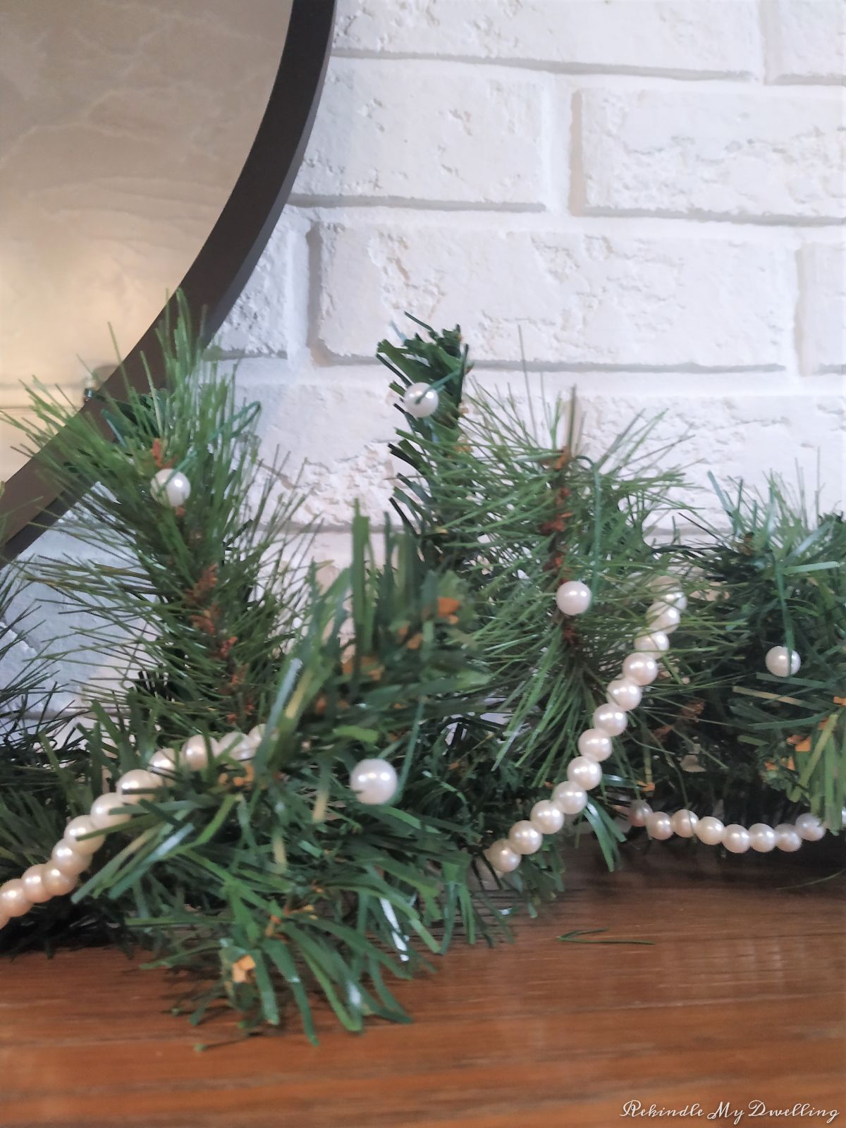 Pearl garland wrapped around greenery.