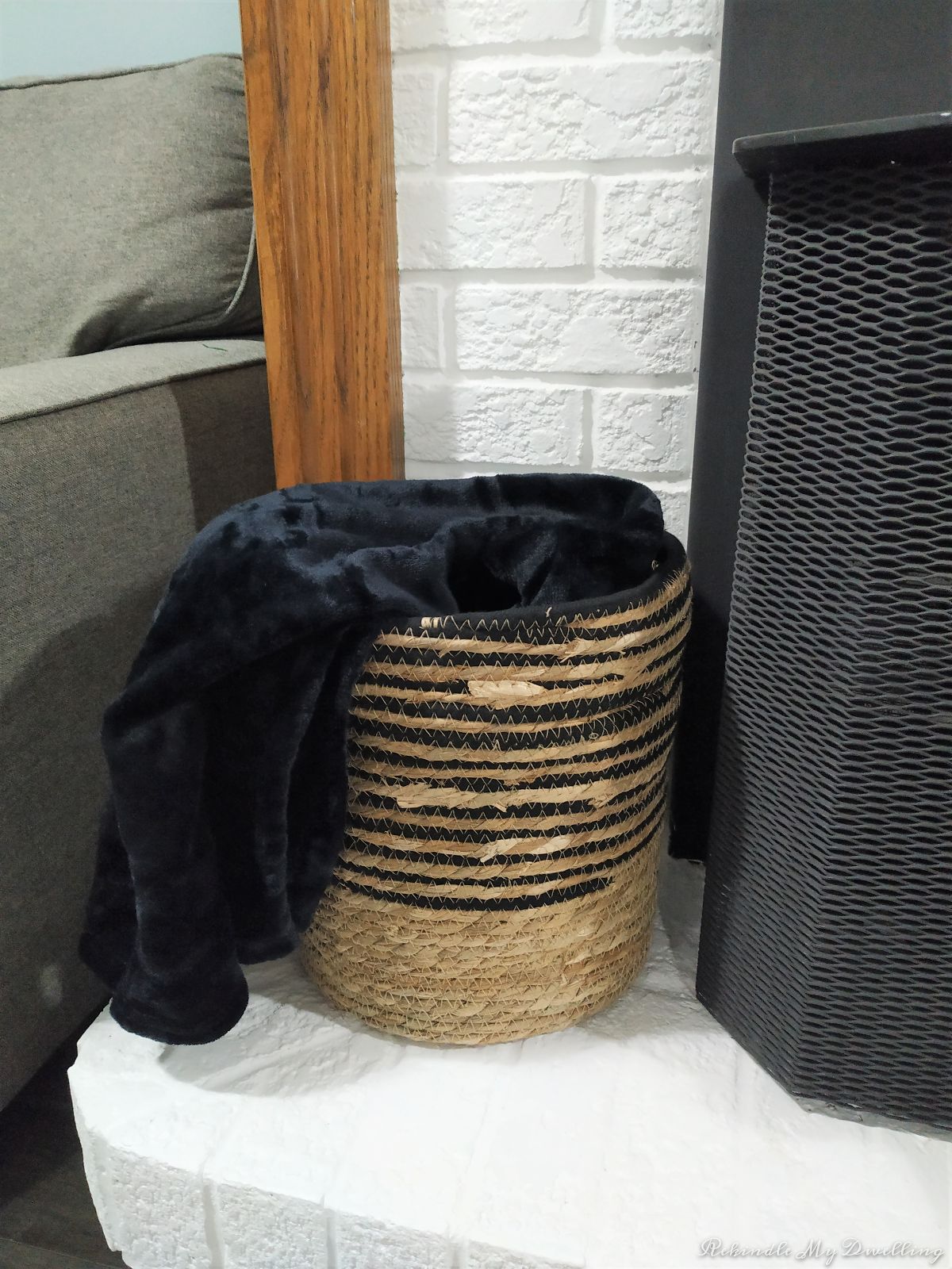 Black blanket inside a basket.