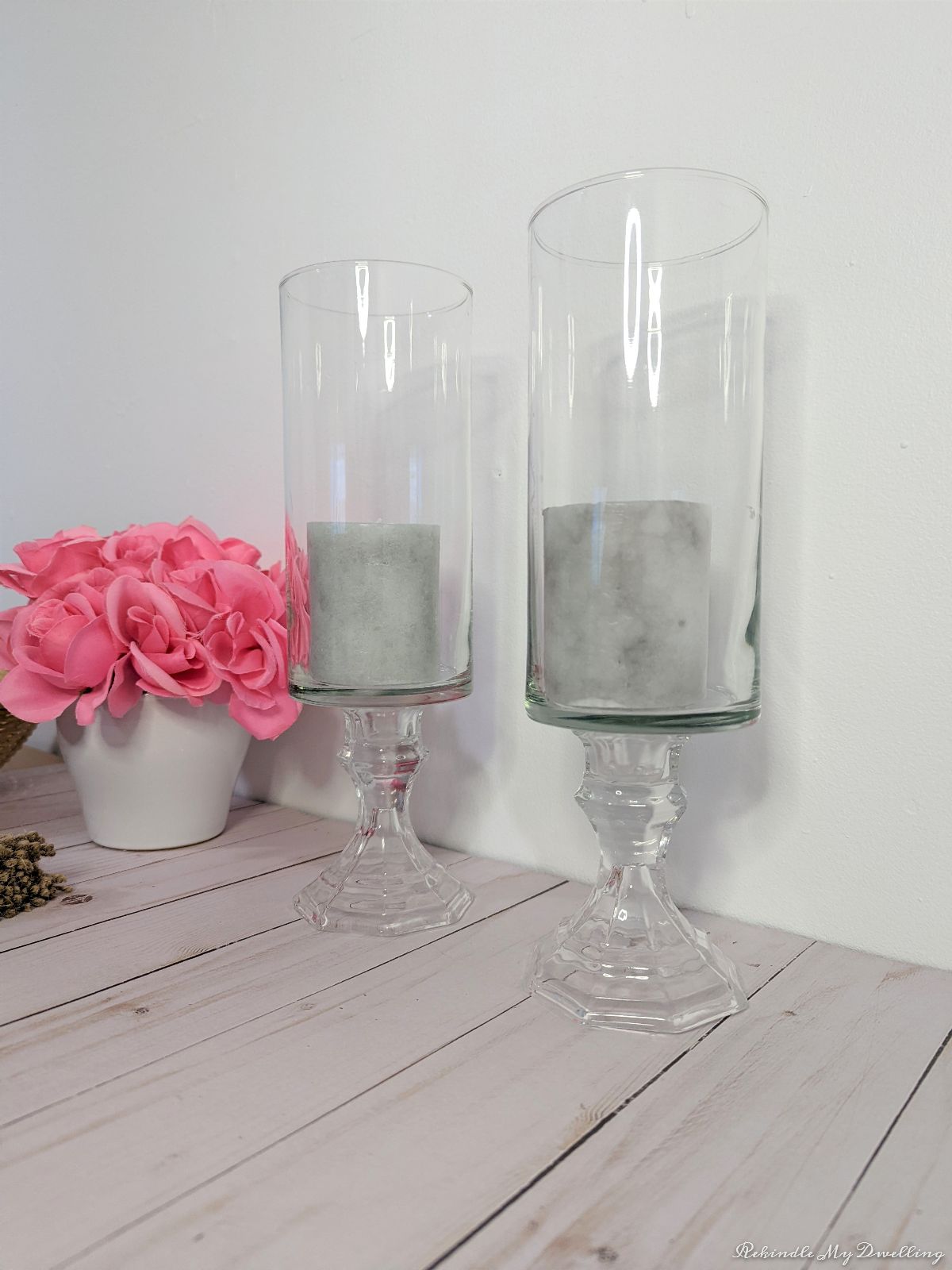 Pedestal vases with candles.