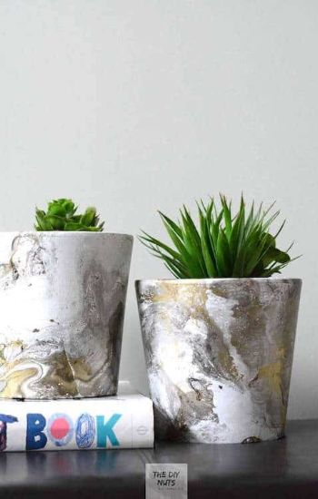 Marbled flower pots with greenery.