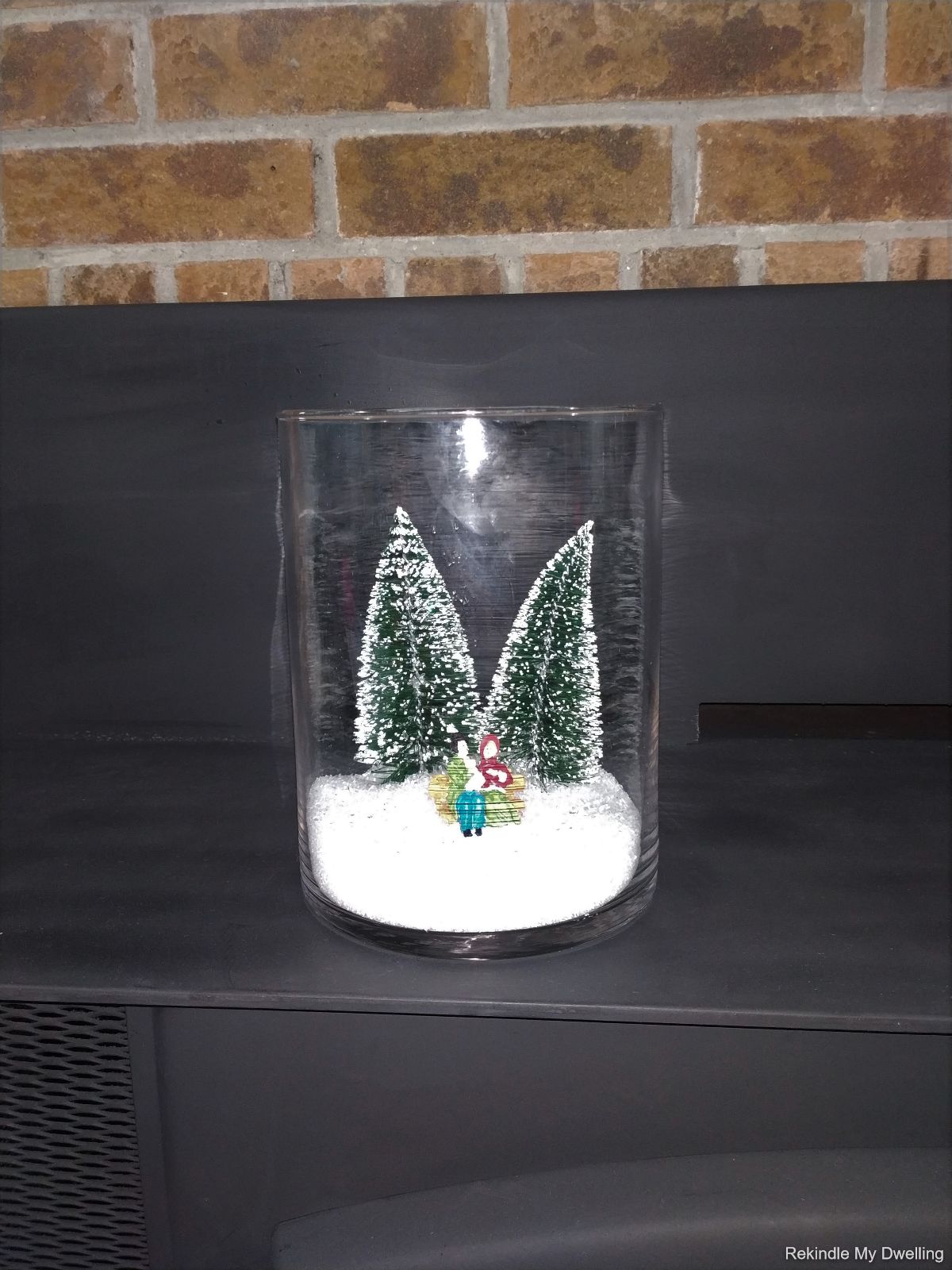 Dollar store decorative Christmas jar placed on a fireplace mantel.
