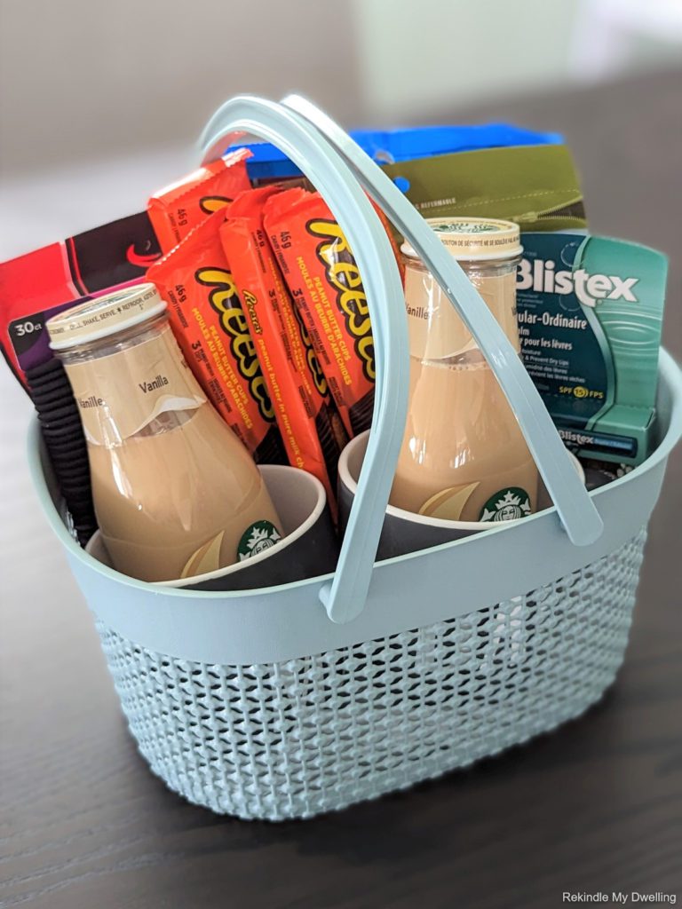 Dollar store gift basket idea filled with snacks, coffee, mugs and personal care items.