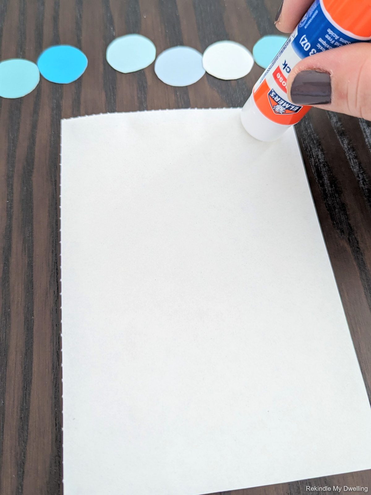 Adding glue onto a paper.