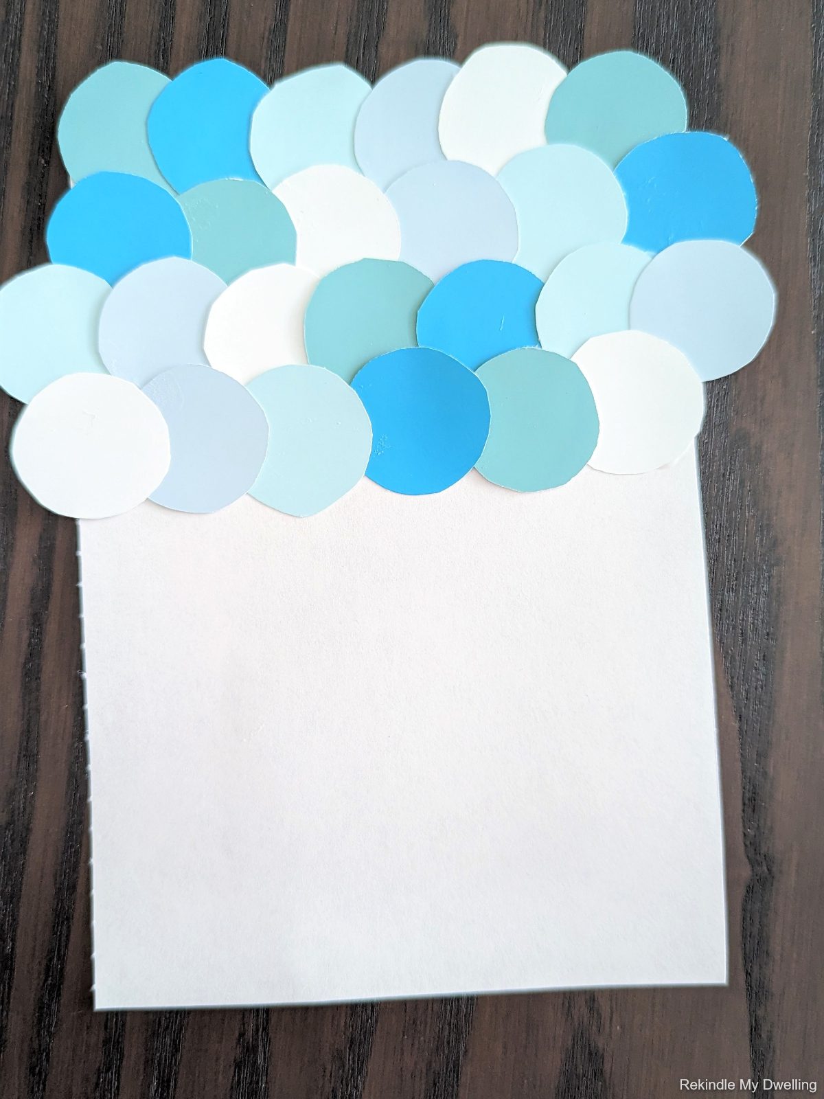 Paper circles glued onto a paper in layers.