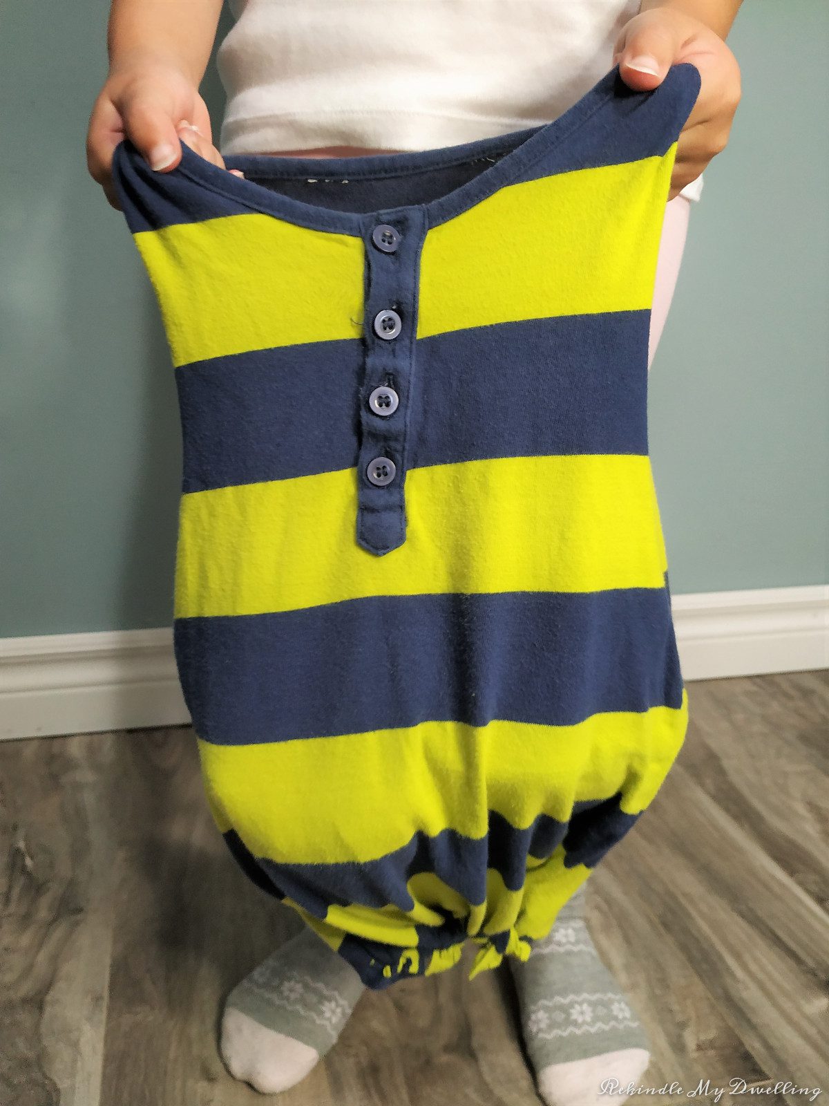 Child holding open a no-sew tshirt bag.