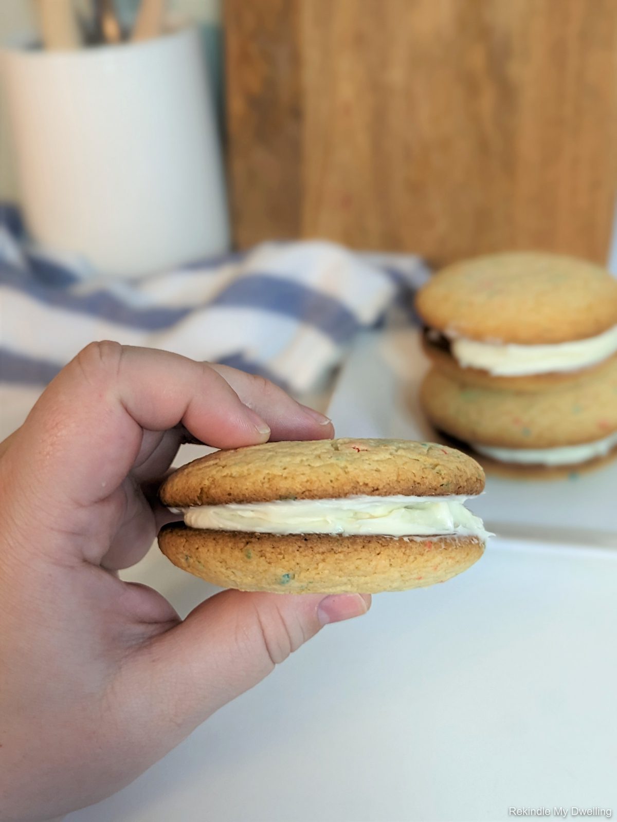 Hand holding a cake mix cookie sandwich.