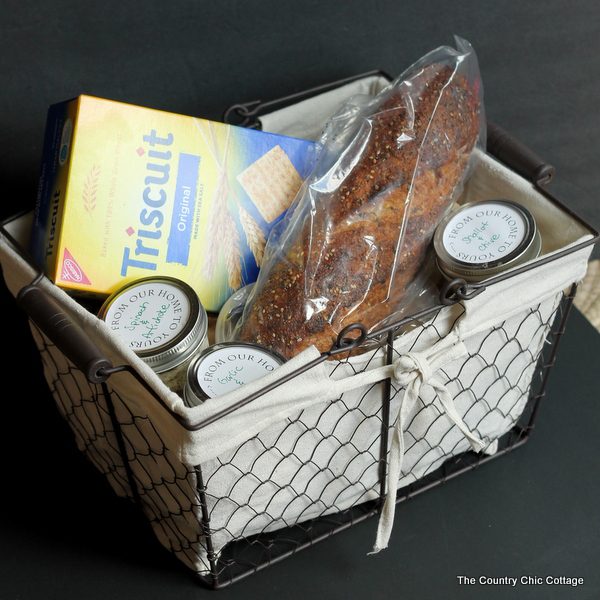 Gift basket filled with cheese, bread and crackers.