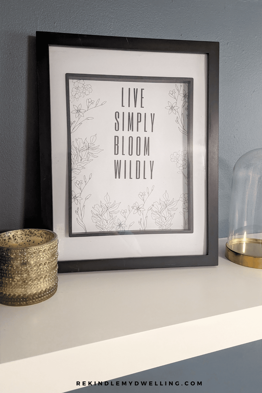 Free minimalist flower printable in a frame and displayed on a shelf.