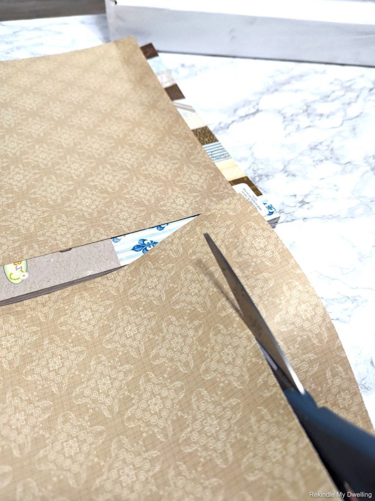 Cutting pieces of scrap paper.