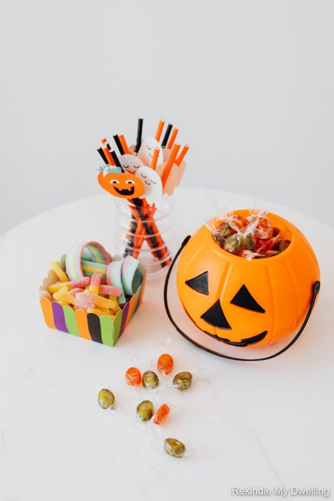 Halloween bucket with candy and toys.