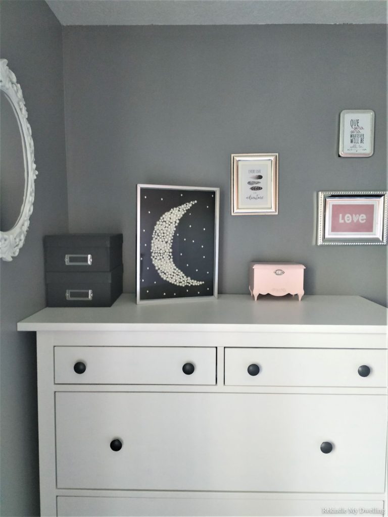 Diy moon decor displayed on a dresser alongside decor.