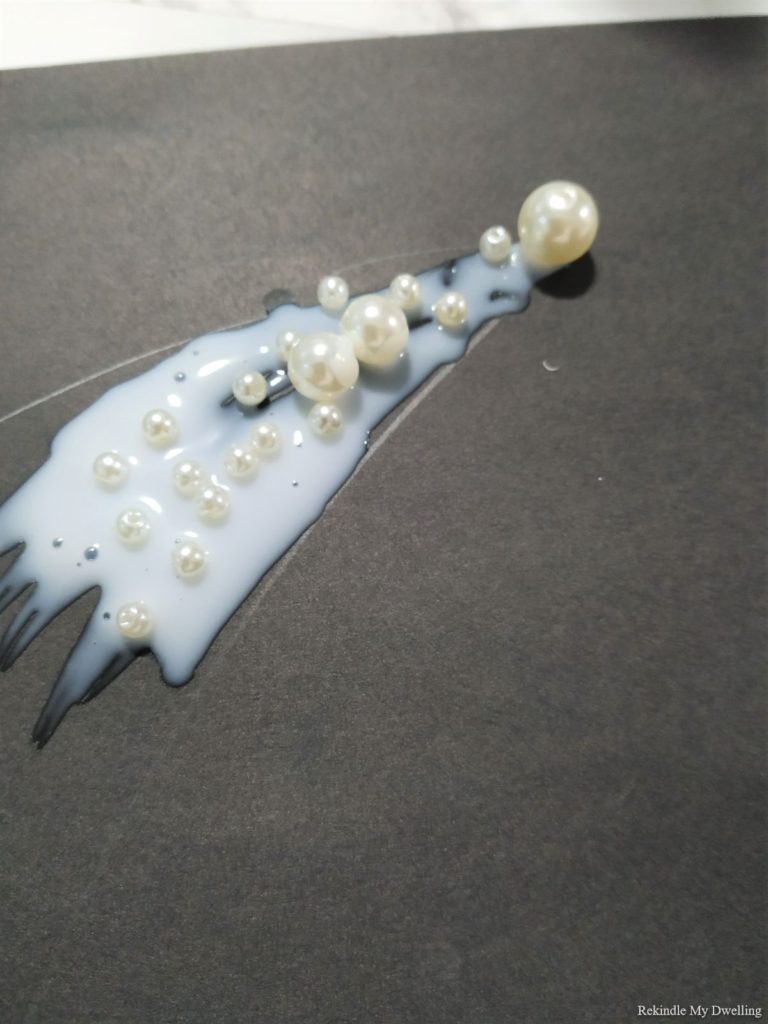 Adding pearls to cover glue.