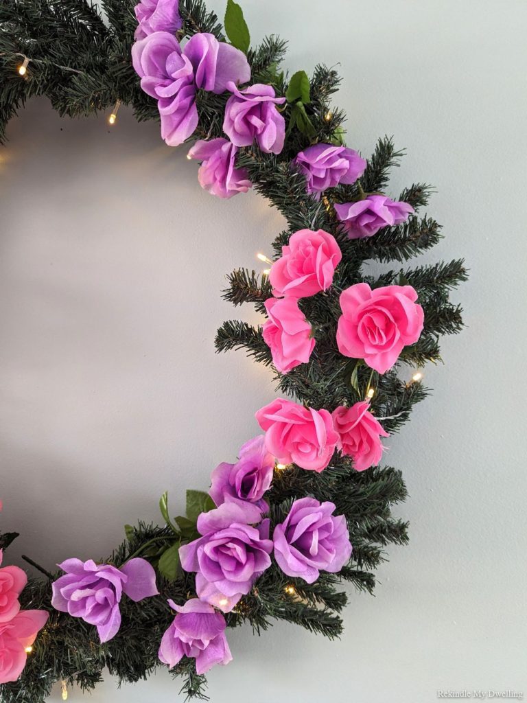 Spring wreath with dollar store flowers and twinkling lights.