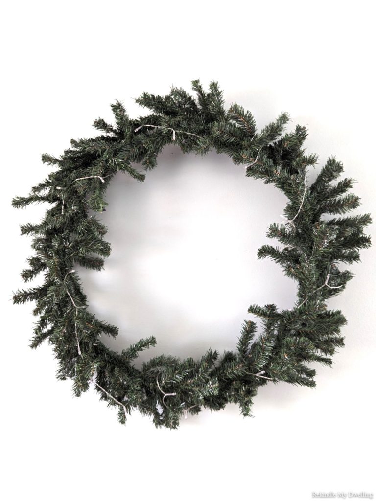 Evergreen wreath with twinkling lights.