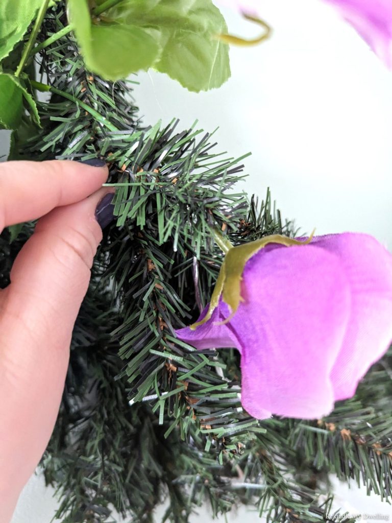 Wrapping the wreath around a flower stem.