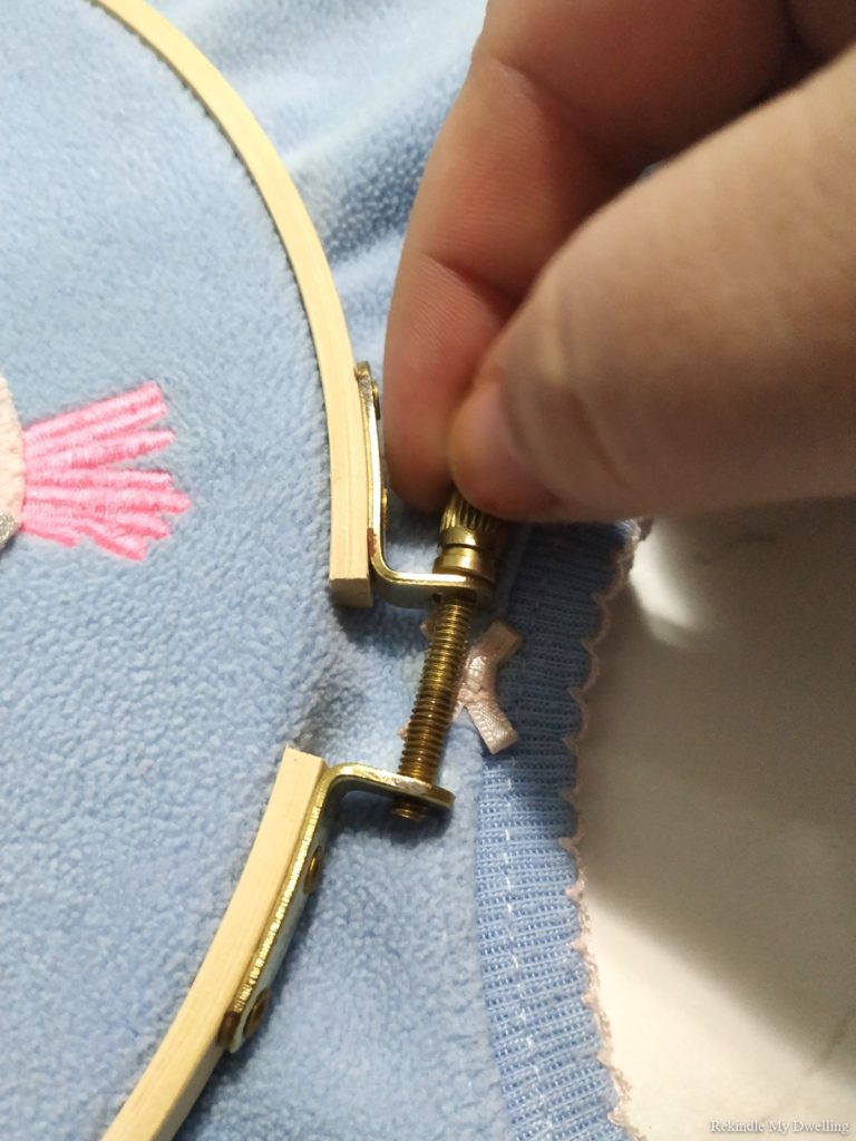 Tightening an embroidery hoop.