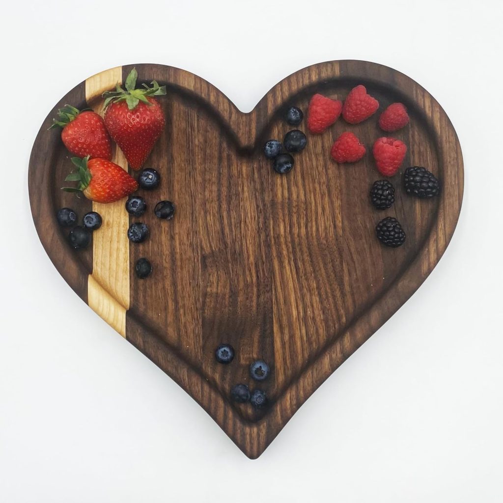 Heart shaped charcuterie board with fruit on it.