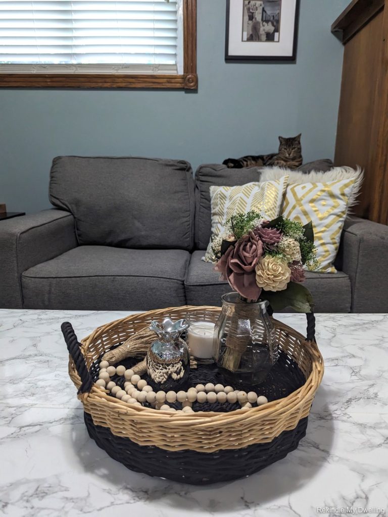 Thrift store basket makeover, with finished basked on a table with decor.