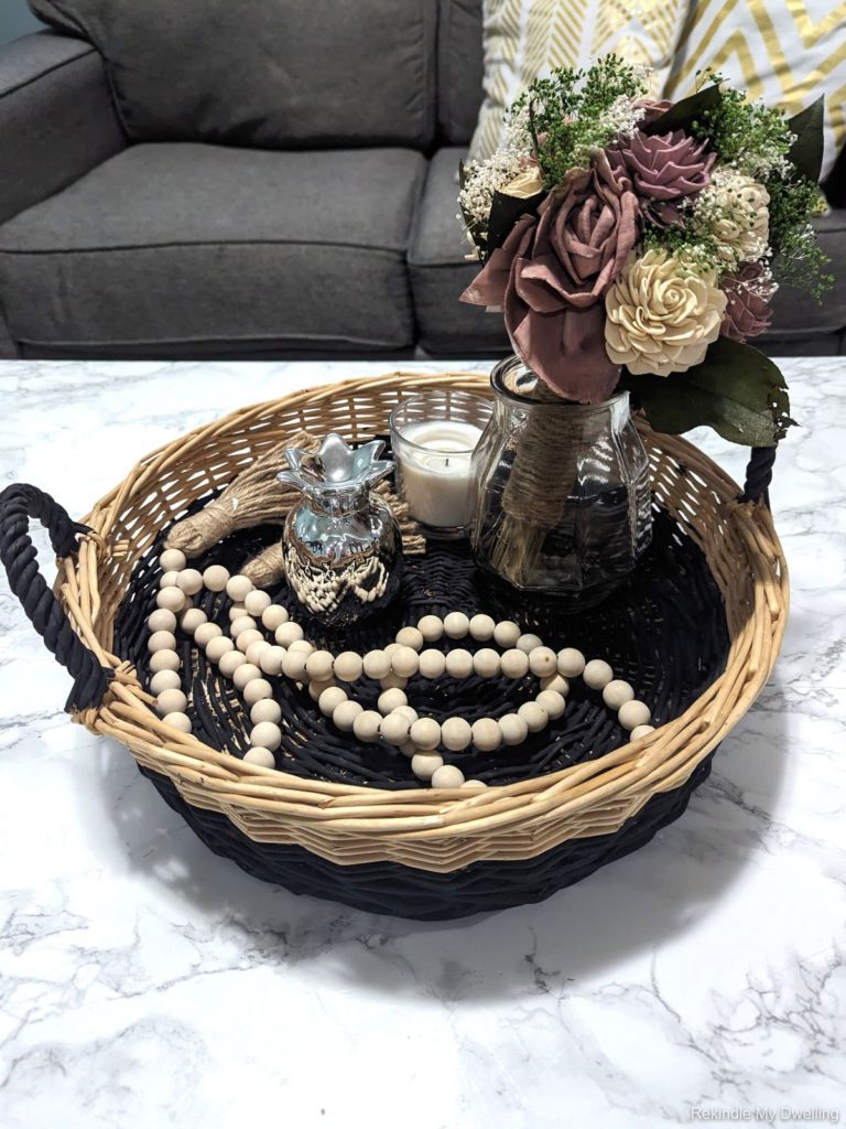 Thrift store basket makeover, with finished basked on a table with decor.