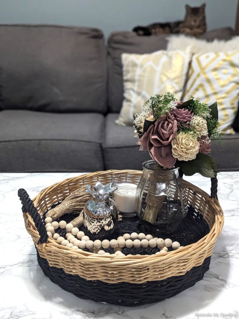 Thrift store basket makeover, with finished basked on a table with decor.