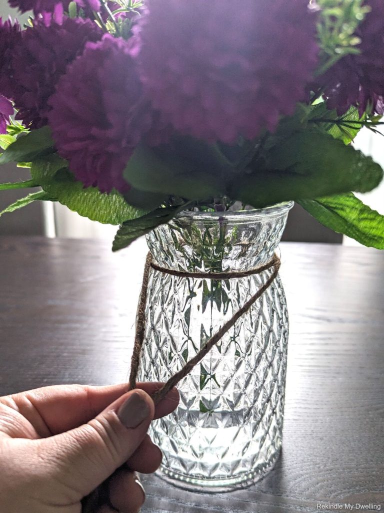 Wrapping twine around the vase.